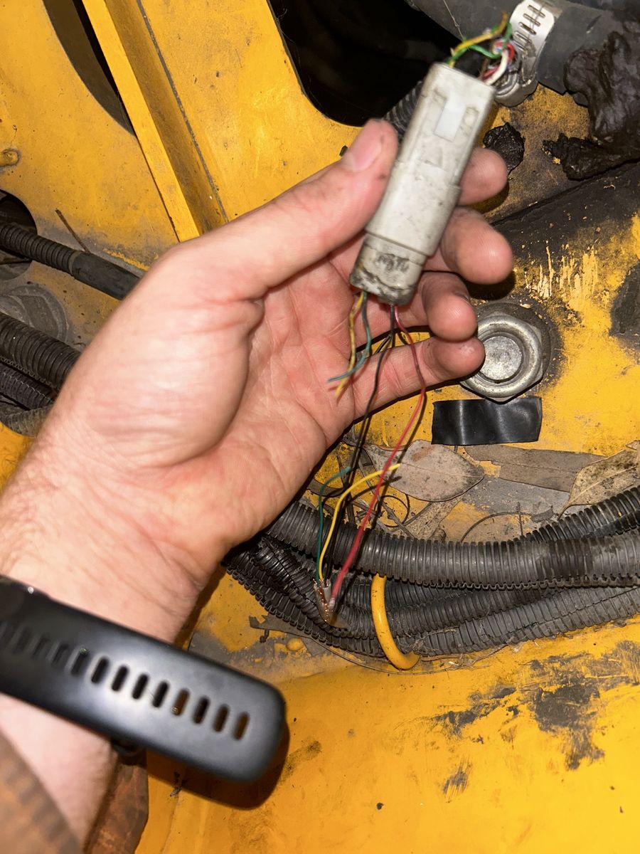Damaged connector and harness on a machine